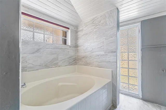 a bath tub sitting next to a window