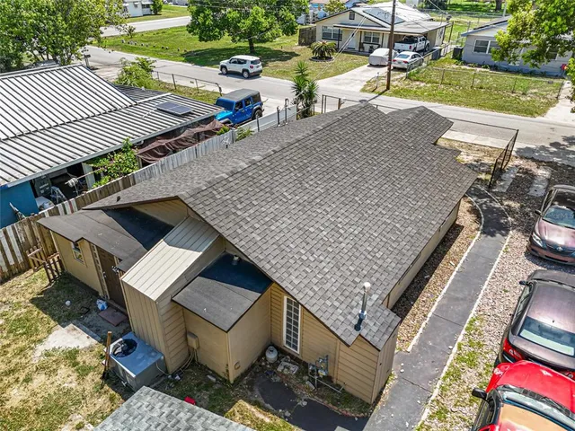 an aerial view of a house with a yard and lake view