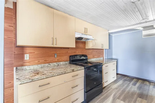 a kitchen with granite countertop cabinets stainless steel appliances and sink