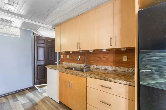 a view of kitchen with granite countertop cabinets and outdoor space