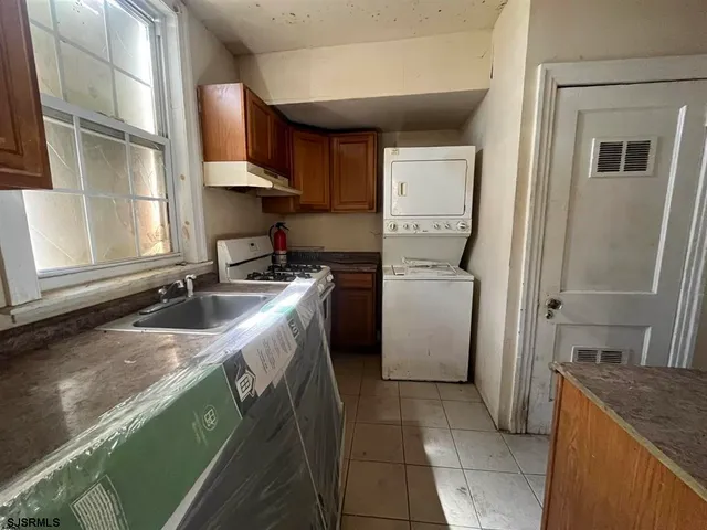 a kitchen with a sink stove and a refrigerator