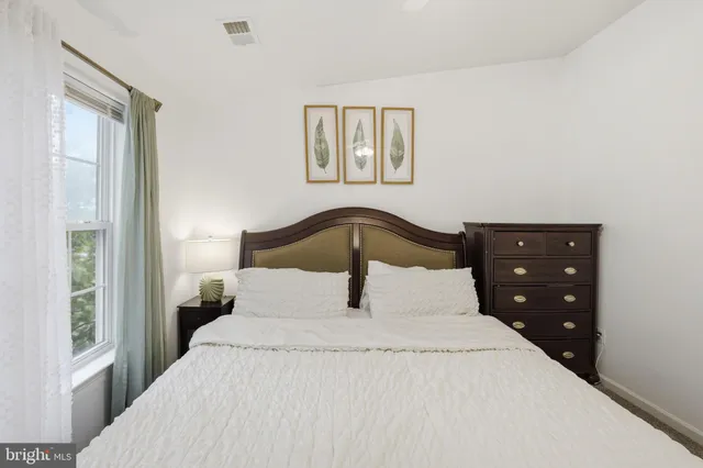 a view of walk in closet with clothes