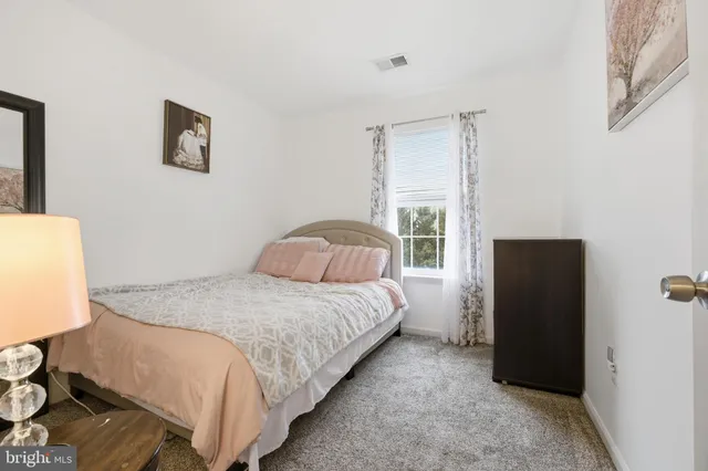 a bedroom with bed and a window