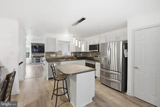 a kitchen with stainless steel appliances a refrigerator stove microwave and cabinets