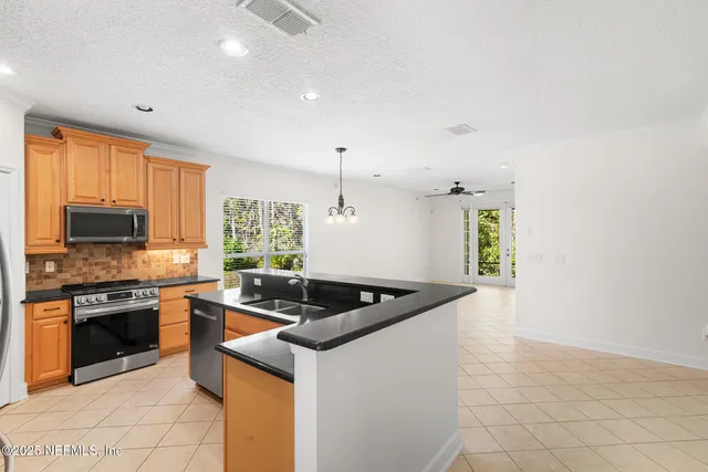 a view of an empty room with fireplace and a window
