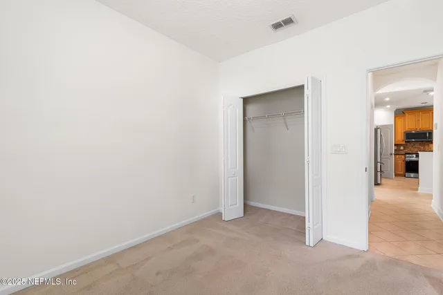 a view of a house with garden and a pond