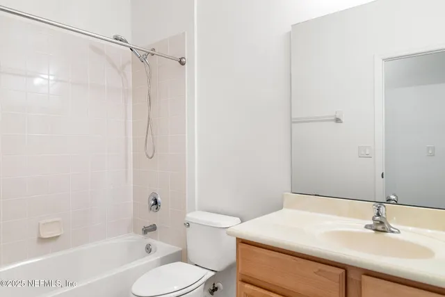 a front view of a house with a garden and trees