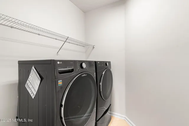 a front view of a house with a yard and potted plants