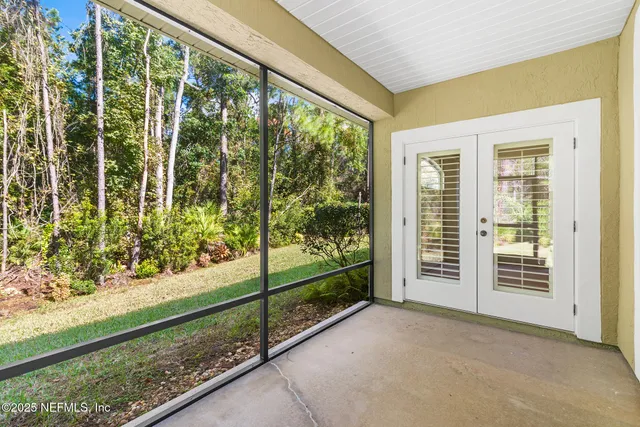 a view of a swimming pool a chair and palm trees