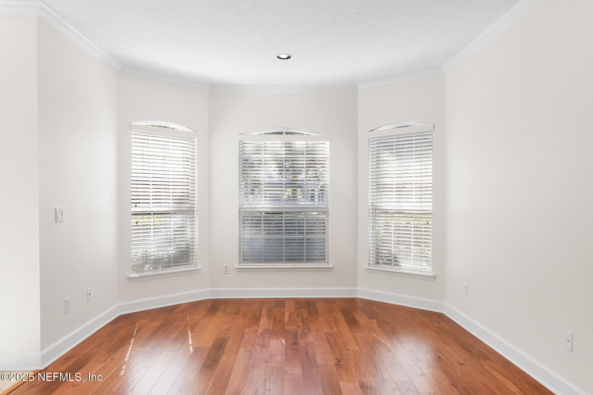 6121 Caladesi Court Jacksonville, FL 32258 - Photo 6 of 44 a view of an empty room with wooden floor and a window