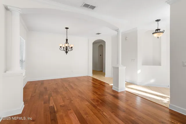 a view of a room with wooden floor and bathroom