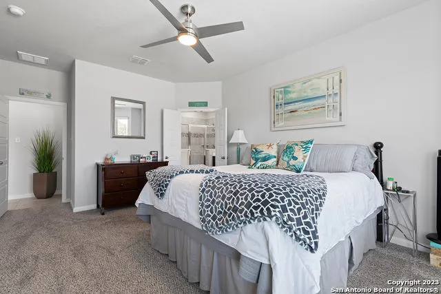 a bed room with a bed and a chandelier