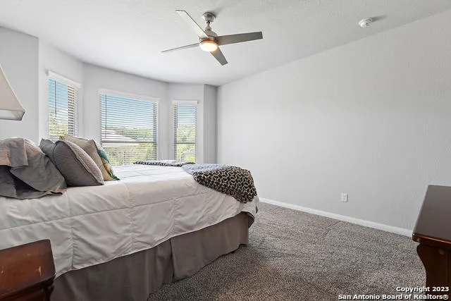 a bedroom with a bed dresser and a window