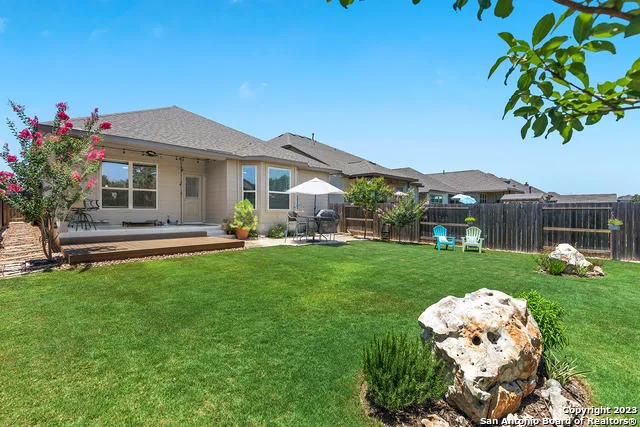 a front view of a house with a garden and yard