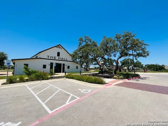 a view of a park with bench and trees