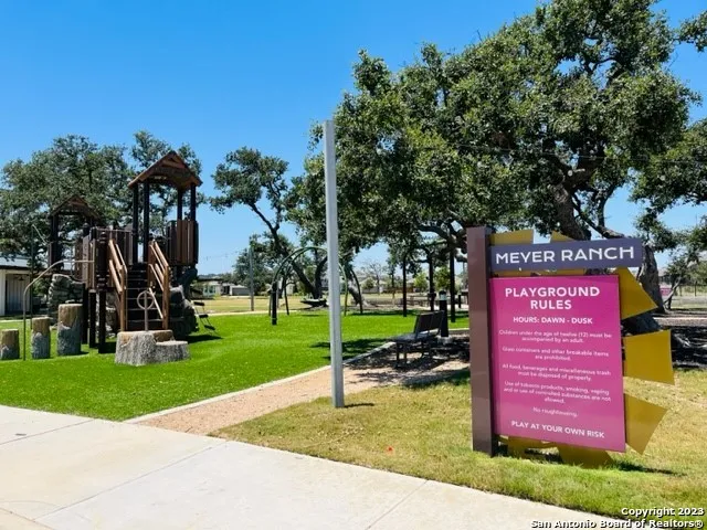an aerial view of a house with a garden and lake view
