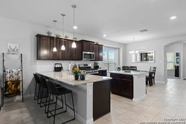 a kitchen with a sink cabinets and stainless steel appliances