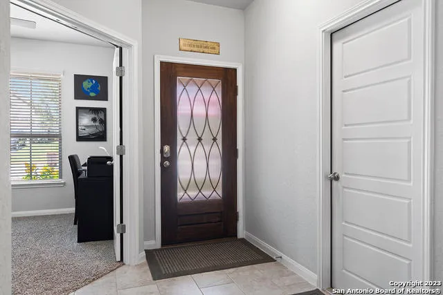 a view of a hallway with wooden cabinets