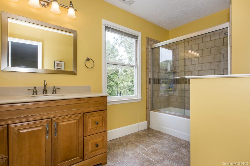 7131 Ramsgate Road Charlotte, NC 28270 - Photo 15 of 24 a bathroom with a sink a mirror and a shower