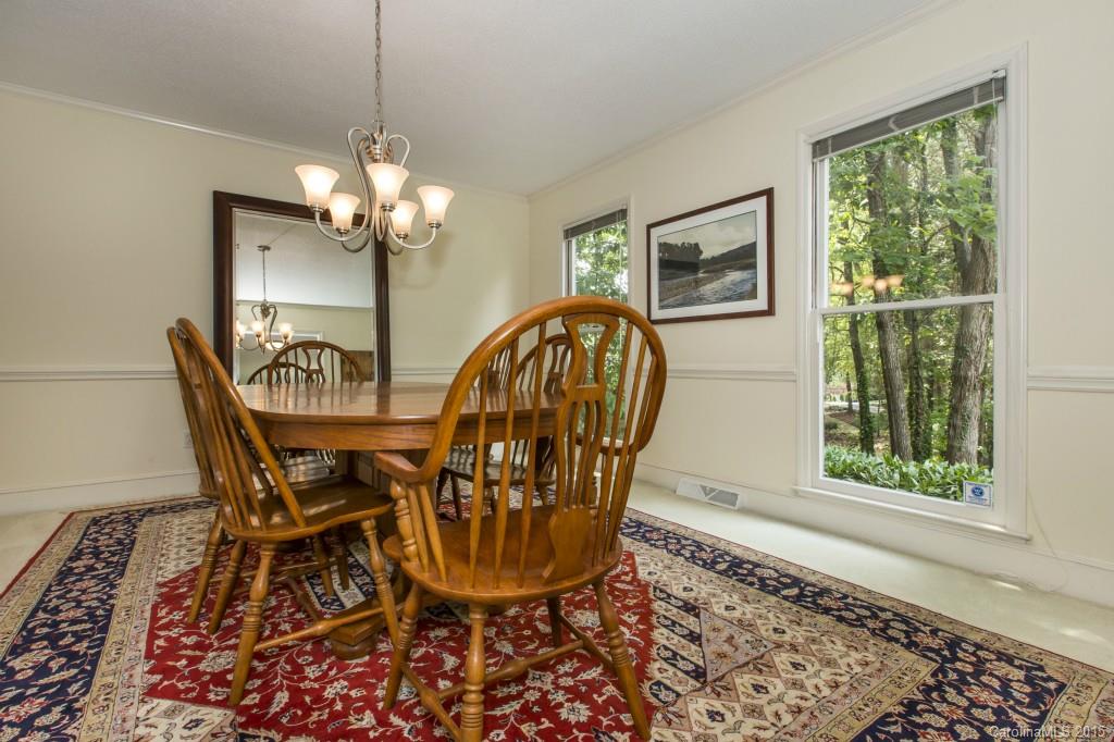 7131 Ramsgate Road Charlotte, NC 28270 - Photo 4 of 24 a view of a dining room with furniture wooden floor and chandelier