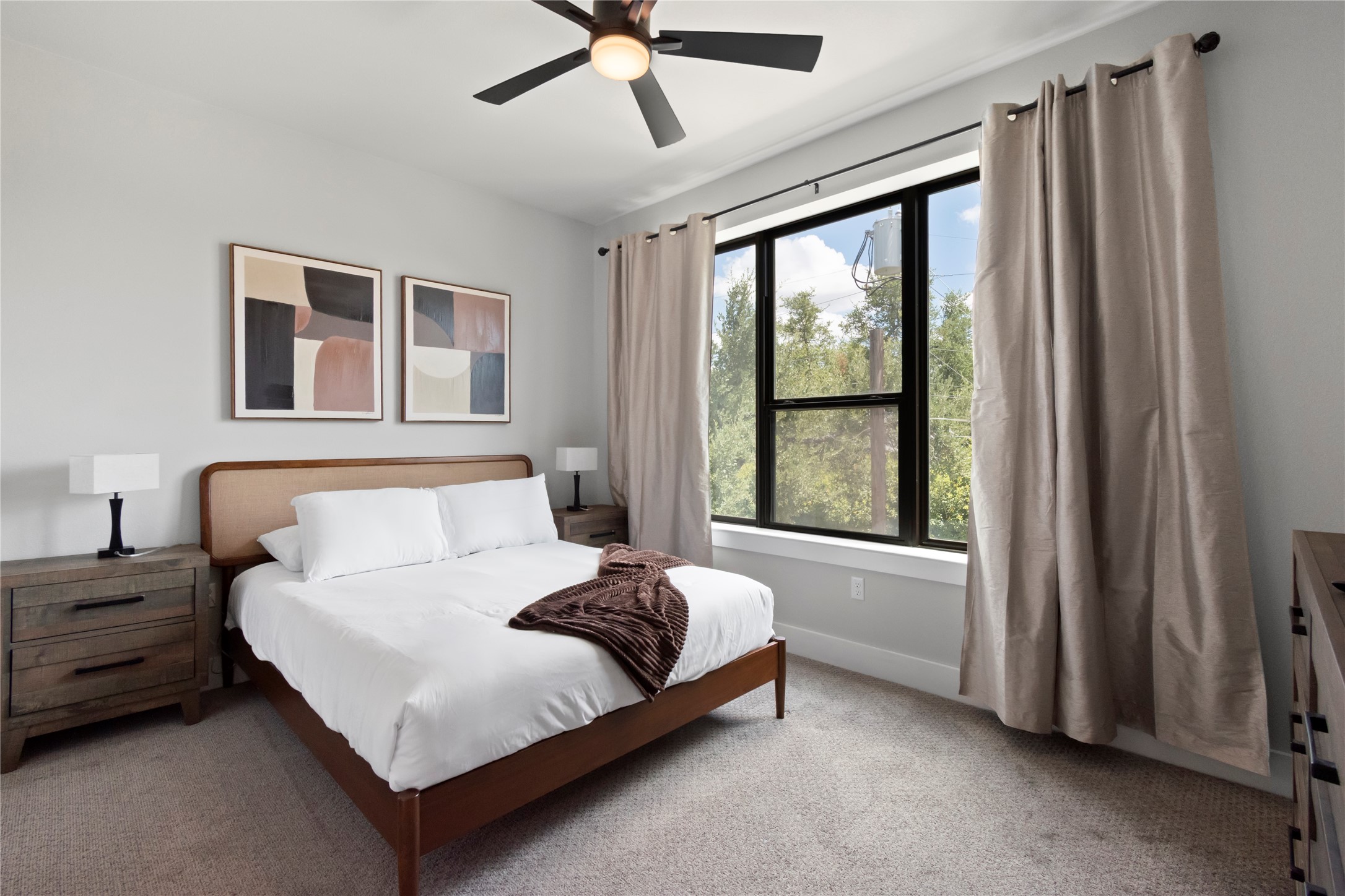13309 Morris Road, Unit 62 Austin, TX 78729 - Photo 14 of 21 A tranquil bedroom retreat features a ceiling fan, a generous window, and plush carpeting.