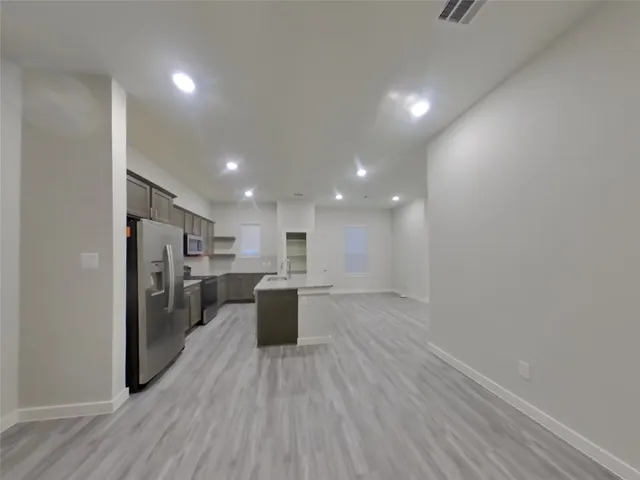 a view of kitchen with cabinets and wooden floor