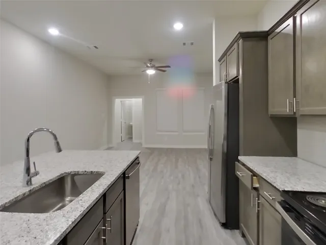 a kitchen with a sink and a refrigerator