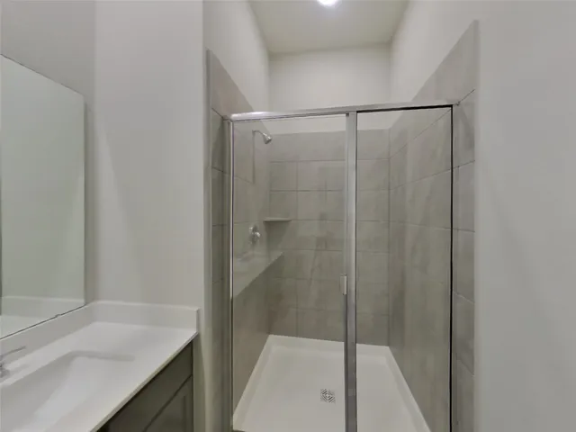 a bathroom with a shower and a sink