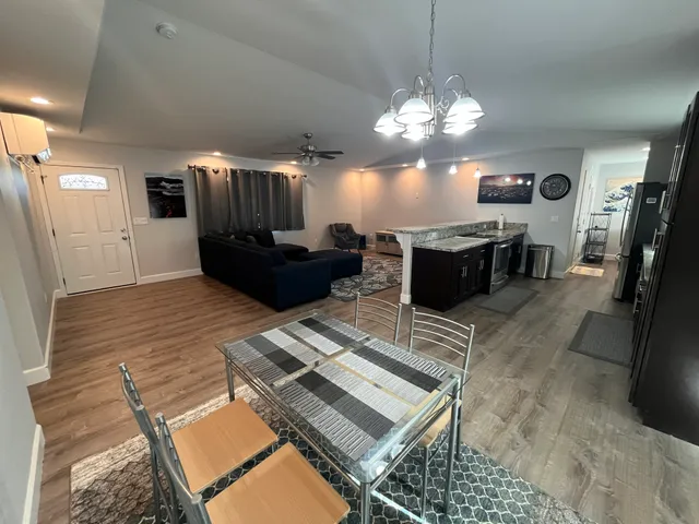 a living room with furniture and a chandelier
