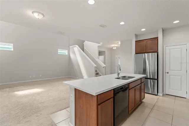 a kitchen with a sink a refrigerator and a stove