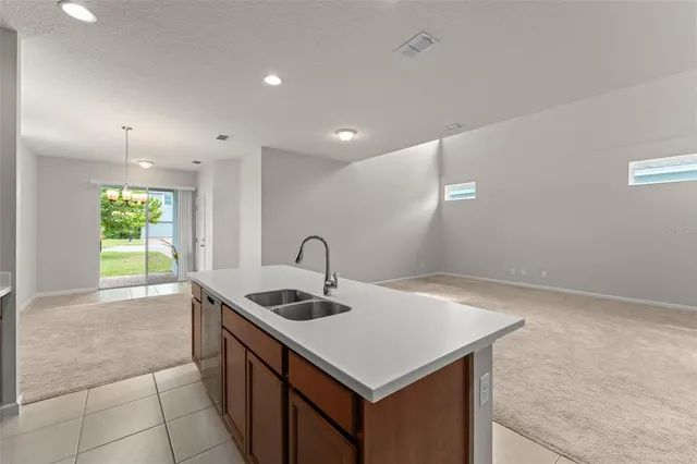 a kitchen that has a sink a stove and a table in it