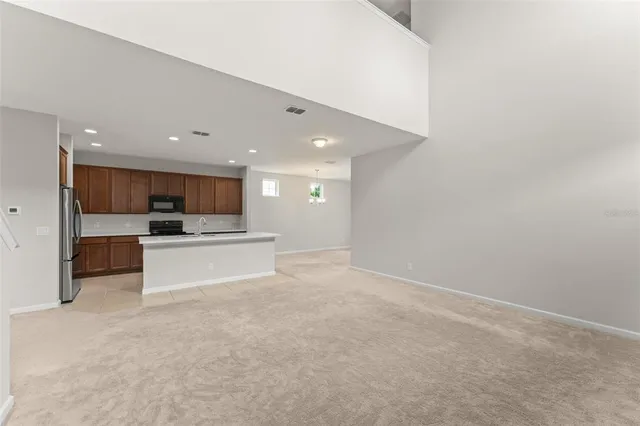 a view of kitchen with kitchen island sink and stove