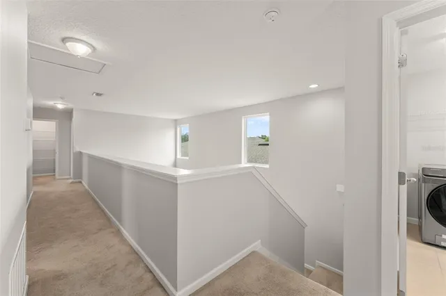 a view of hallway with washer and dryer