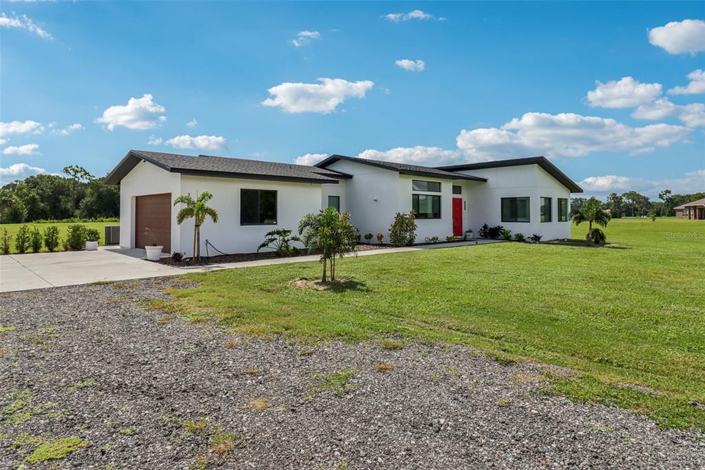 a front view of house with yard and green space