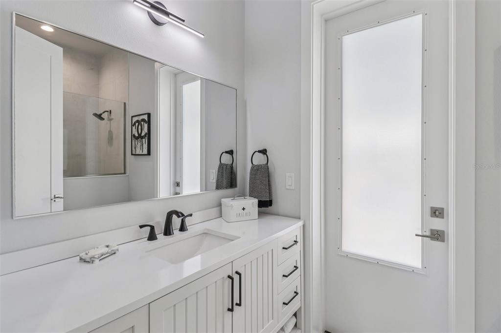 3385 Lake Diane Road Tavares, FL 32778 - Photo 14 of 49 a bathroom with a double vanity sink and a mirror