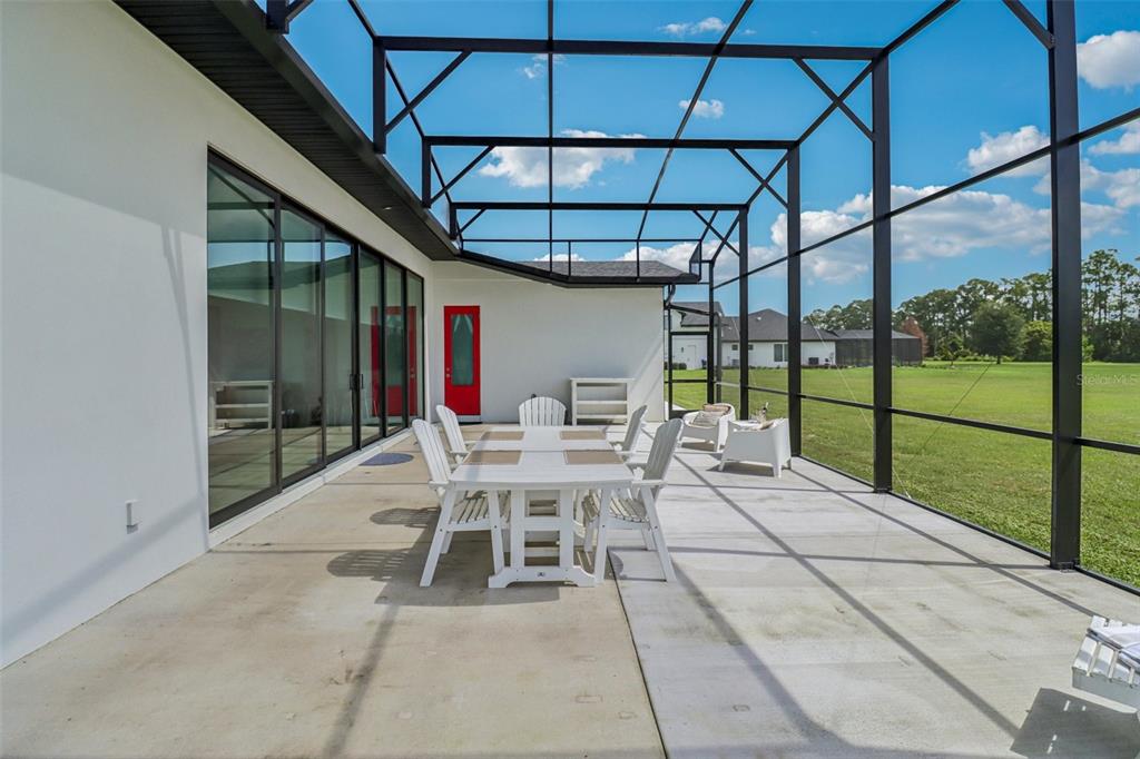 3385 Lake Diane Road Tavares, FL 32778 - Photo 27 of 49 a view of a patio with a table and chairs and floor to ceiling window