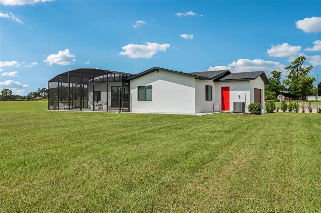 3385 Lake Diane Road Tavares, FL 32778 - Photo 32 of 49 a front view of a house with a yard and garage