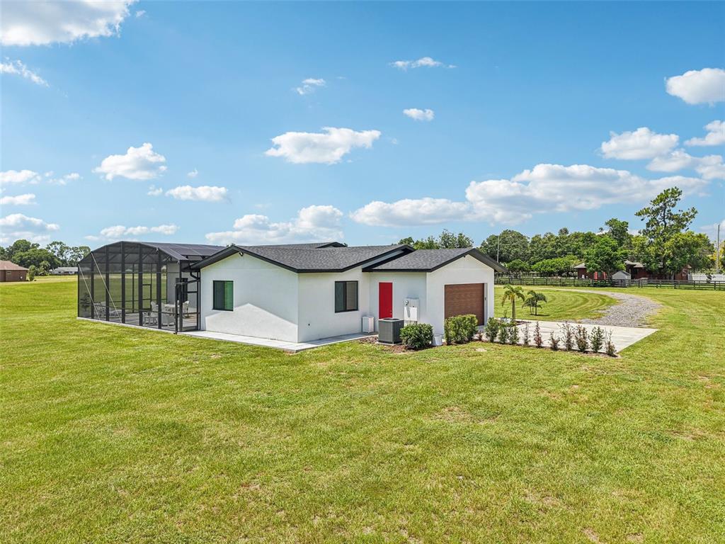 3385 Lake Diane Road Tavares, FL 32778 - Photo 34 of 49 a view of a house with a yard and garage