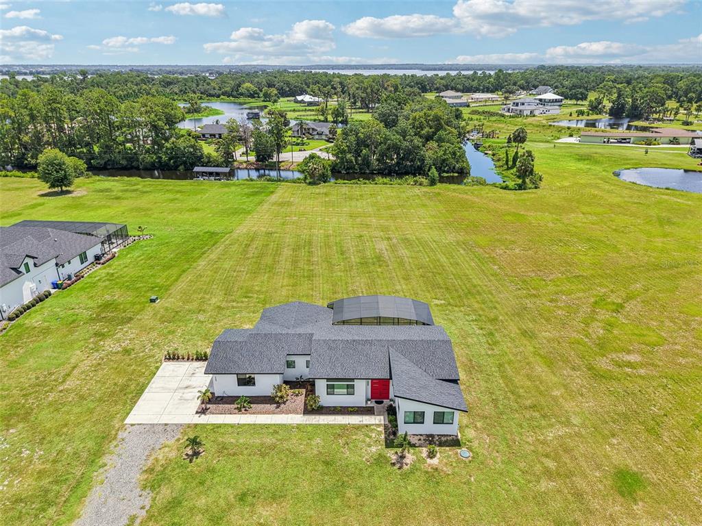 3385 Lake Diane Road Tavares, FL 32778 - Photo 37 of 49 a aerial view of a house with a garden