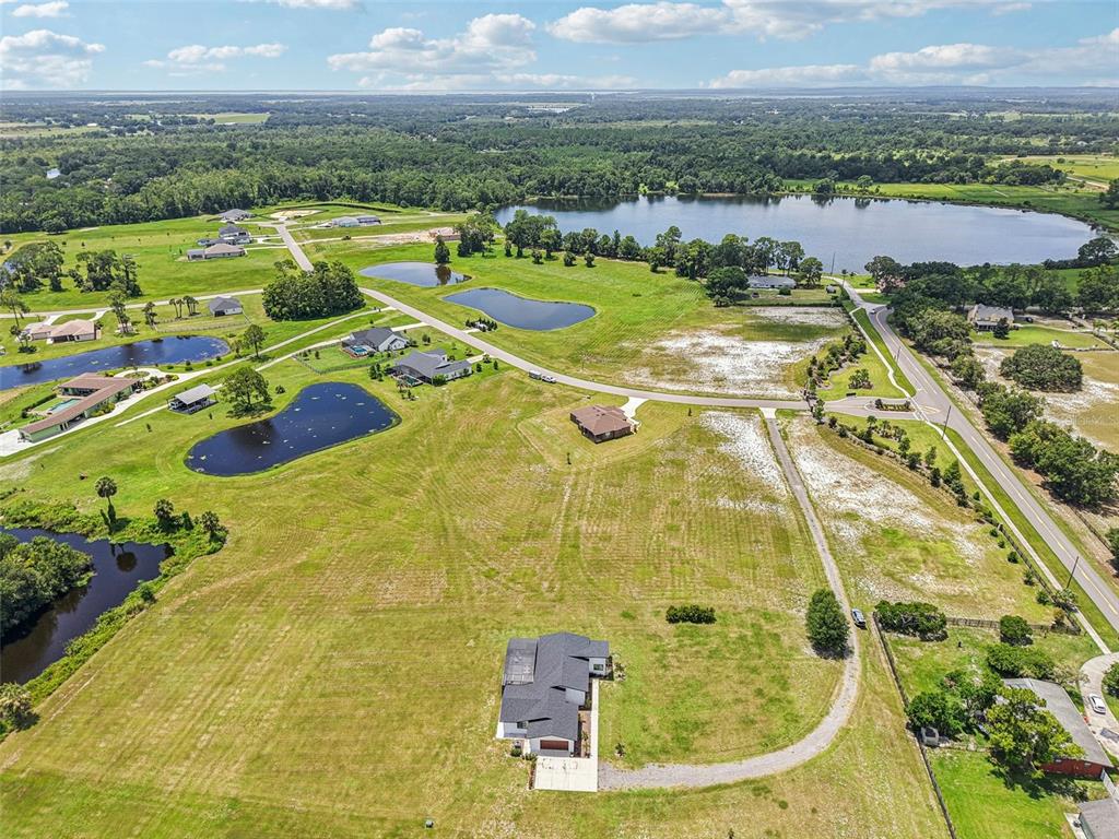 3385 Lake Diane Road Tavares, FL 32778 - Photo 39 of 49 a view of a swimming pool with a lot of trees & houses