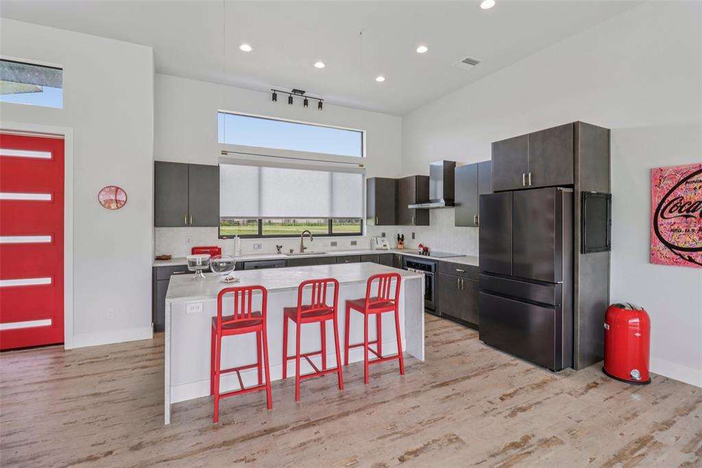 3385 Lake Diane Road Tavares, FL 32778 - Photo 10 of 49 a kitchen with stainless steel appliances granite countertop a refrigerator and a stove top oven