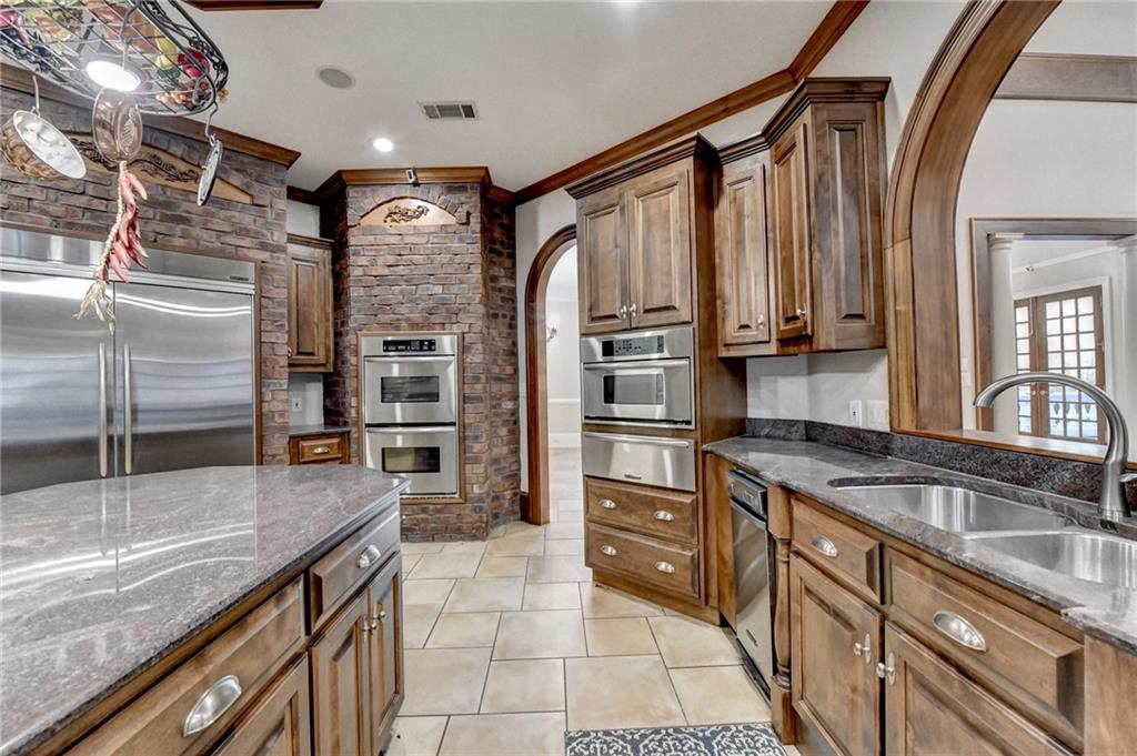 1540 Lipscomb Road Social Circle, GA 30025 - Photo 12 of 130 a kitchen with stainless steel appliances granite countertop a sink a stove and a refrigerator