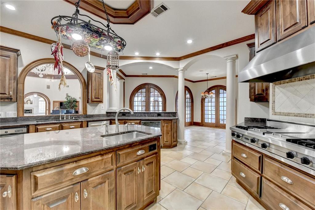 1540 Lipscomb Road Social Circle, GA 30025 - Photo 18 of 130 a kitchen with stainless steel appliances granite countertop a sink a stove and cabinets