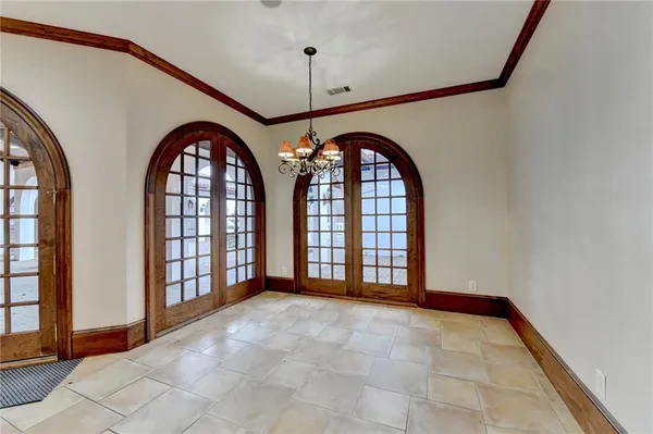 a view of an empty room with a fireplace and a window