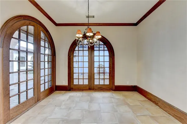 a view of an empty room with a fireplace and a window