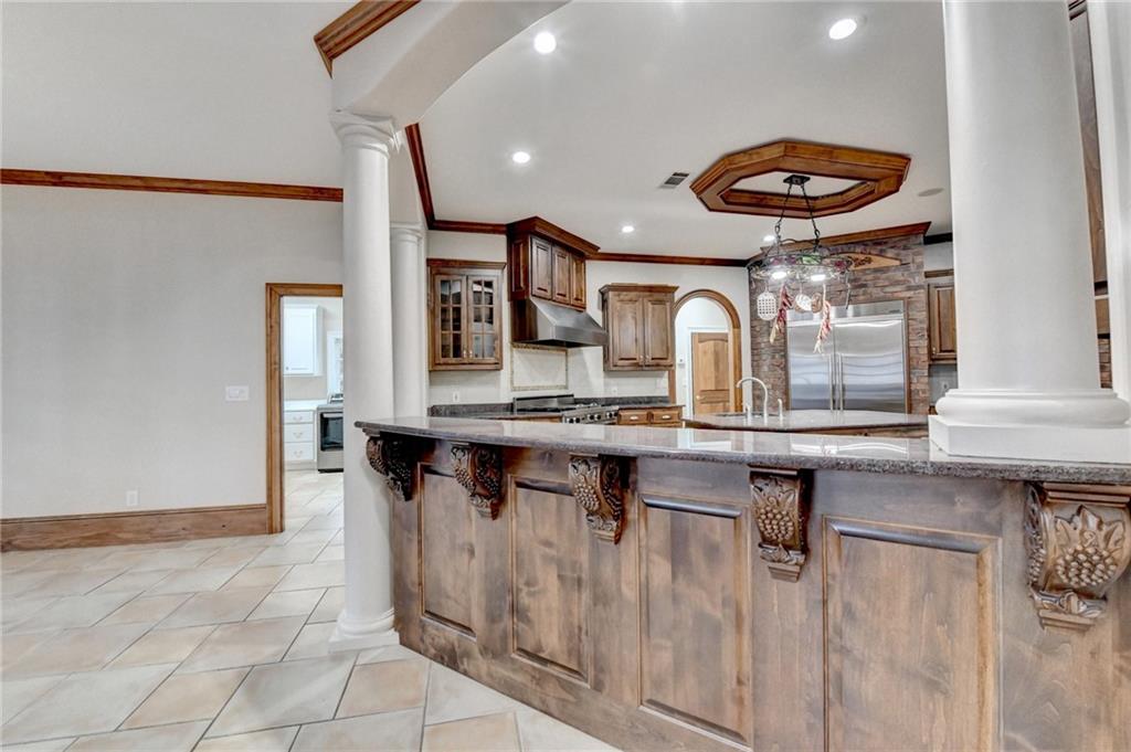 1540 Lipscomb Road Social Circle, GA 30025 - Photo 24 of 130 a kitchen with stainless steel appliances granite countertop a sink and a stove
