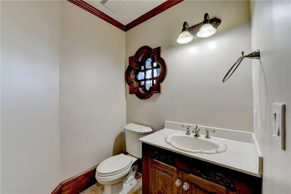 a kitchen with stainless steel appliances granite countertop a stove a sink and a white cabinets