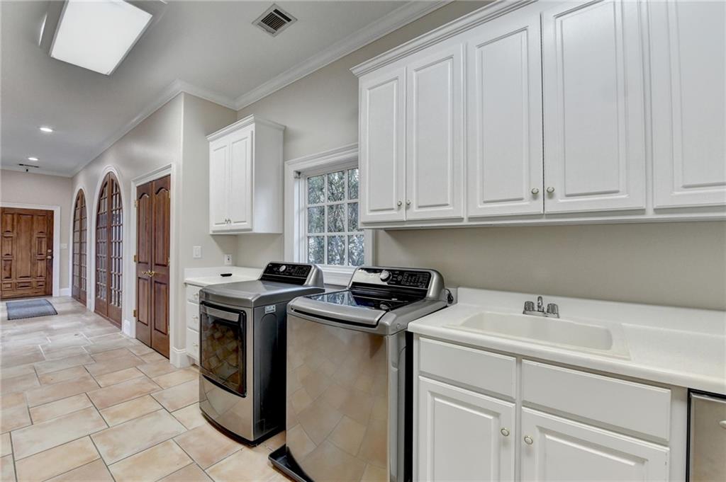 1540 Lipscomb Road Social Circle, GA 30025 - Photo 67 of 130 a kitchen with stainless steel appliances granite countertop a stove a sink and a white cabinets
