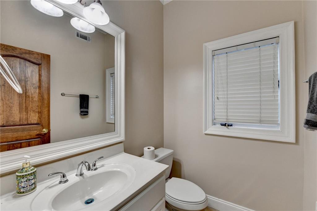 1540 Lipscomb Road Social Circle, GA 30025 - Photo 69 of 130 a bathroom with a sink a toilet and mirror