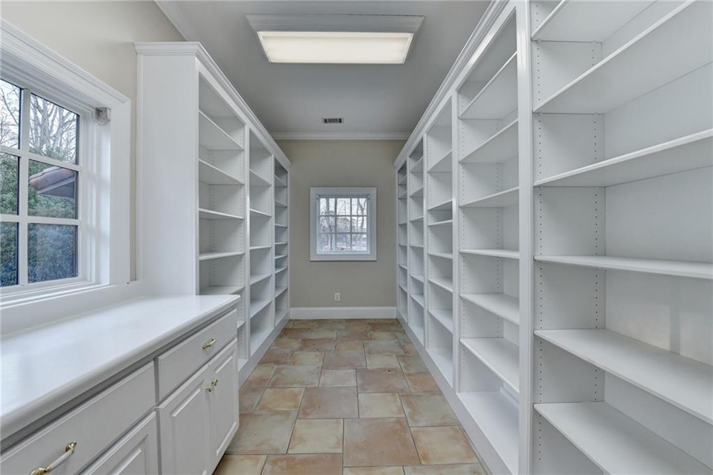 1540 Lipscomb Road Social Circle, GA 30025 - Photo 70 of 130 a view of an empty walk in closet with empty racks